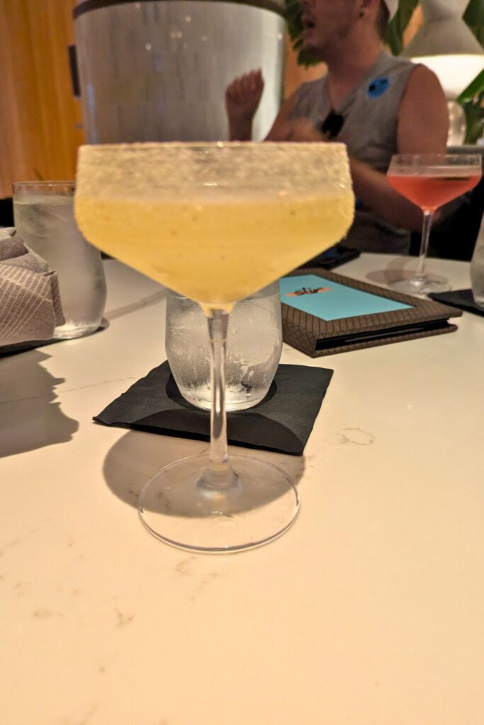 Frosted cocktail glass with light yellow beverage